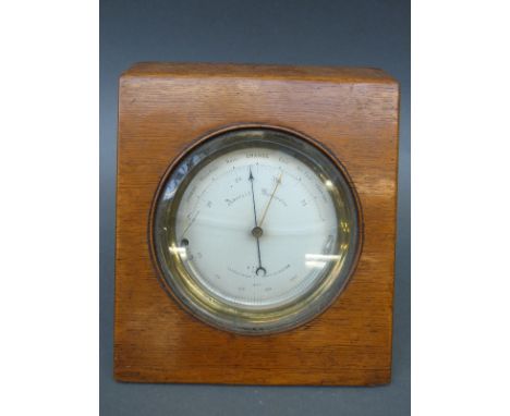 French aneroid barometer in beech case with silvered dial and curved thermometer to lower dial, 12cm dial with bevelled glass