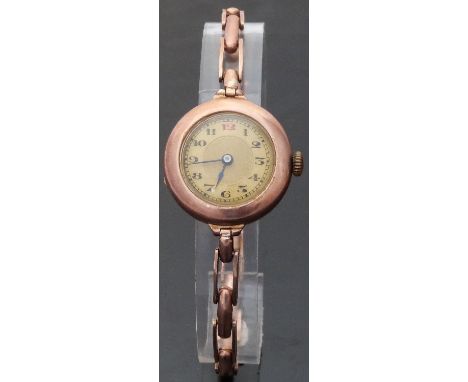 A 9ct gold ladies wristwatch with Arabic numerals, blued hands and engine turned face, on 9ct gold expanding bracelet, case d