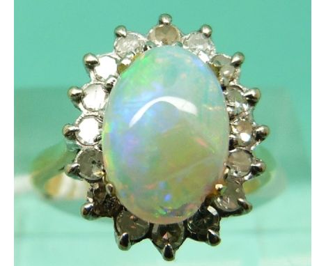 An 18ct gold ring set with an opal cabochon surrounded by diamonds (Size L) 