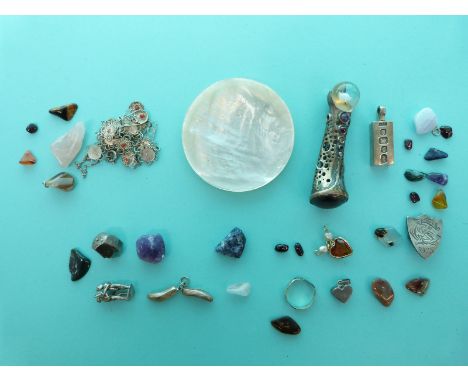 A mother of pearl pin dish, silver ingot, silver brooch, silver charms, a silver item set with various gemstones, a filigree 