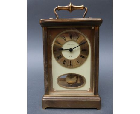 Late 20th century H. Samuel 8 day carriage clock in corniche style brass case, ivory coloured dial with Roman chapter ring an