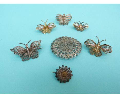 Three white metal gilt filigree brooches in the form of butterflies, a white metal filigree butterfly brooch, white metal dai