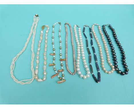 Eight pearl necklaces including a large single strand of Tahitian cultured pearls, freshwater pearls, a three strand pearl ne