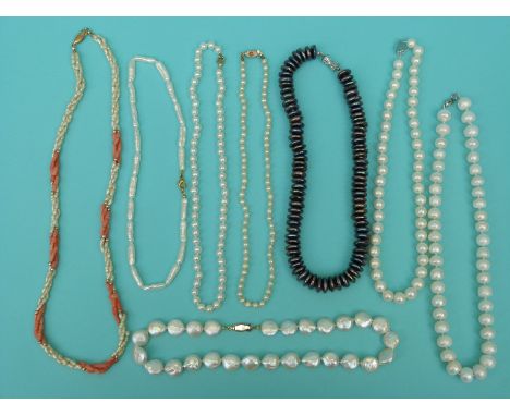 Eight pearl necklaces including a large single strand of freshwater pearls, a coral and pearl necklace, irregular shaped pear