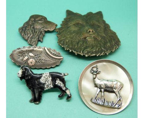 A silver and enamel Kenart brooch in the form of a cocker spaniel, together with an embossed brooch of a terrier, another of 