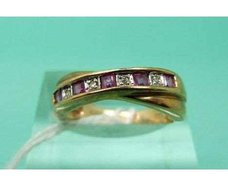 A 9ct gold ring set with alternating rubies and diamonds in a twist setting (Size L)