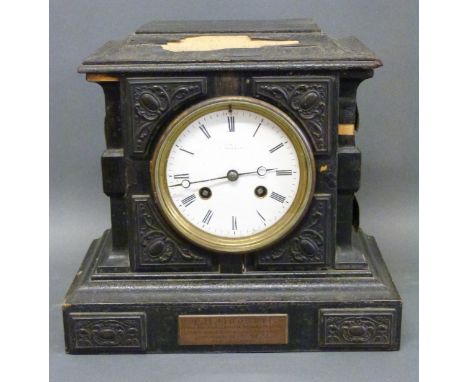 An early 20thC carved wood mantel clock with enamel face with Paris maker's name