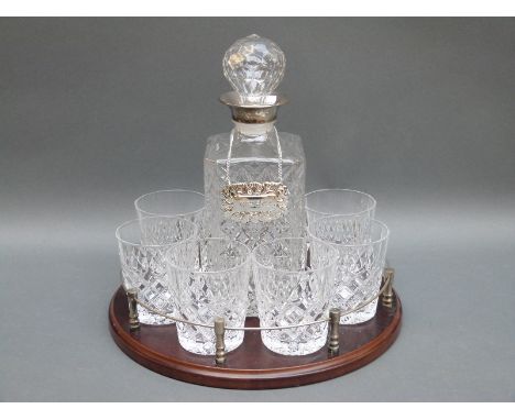 A cut glass whisky set with plated mount to the decanter together on galleried tray, diameter 30cm 