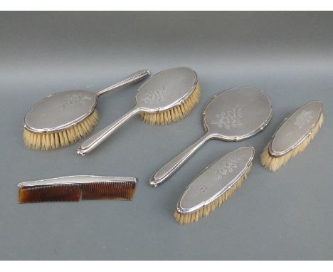 A modern hallmarked silver dressing table set comprising hand mirror, four brushes and comb, all Birmingham 1959 maker Albert