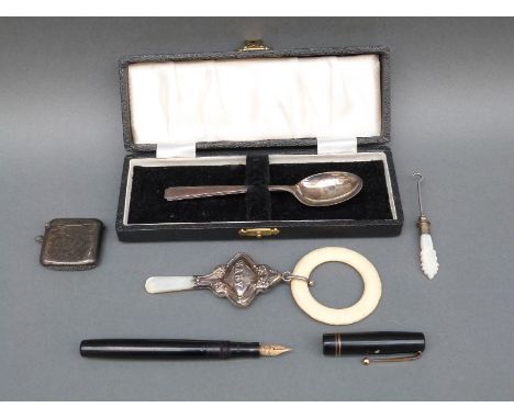 Hallmarked silver vesta, hallmarked silver baby's rattle and teething ring, a cased silver spoon and a Swan pen with 14ct gol