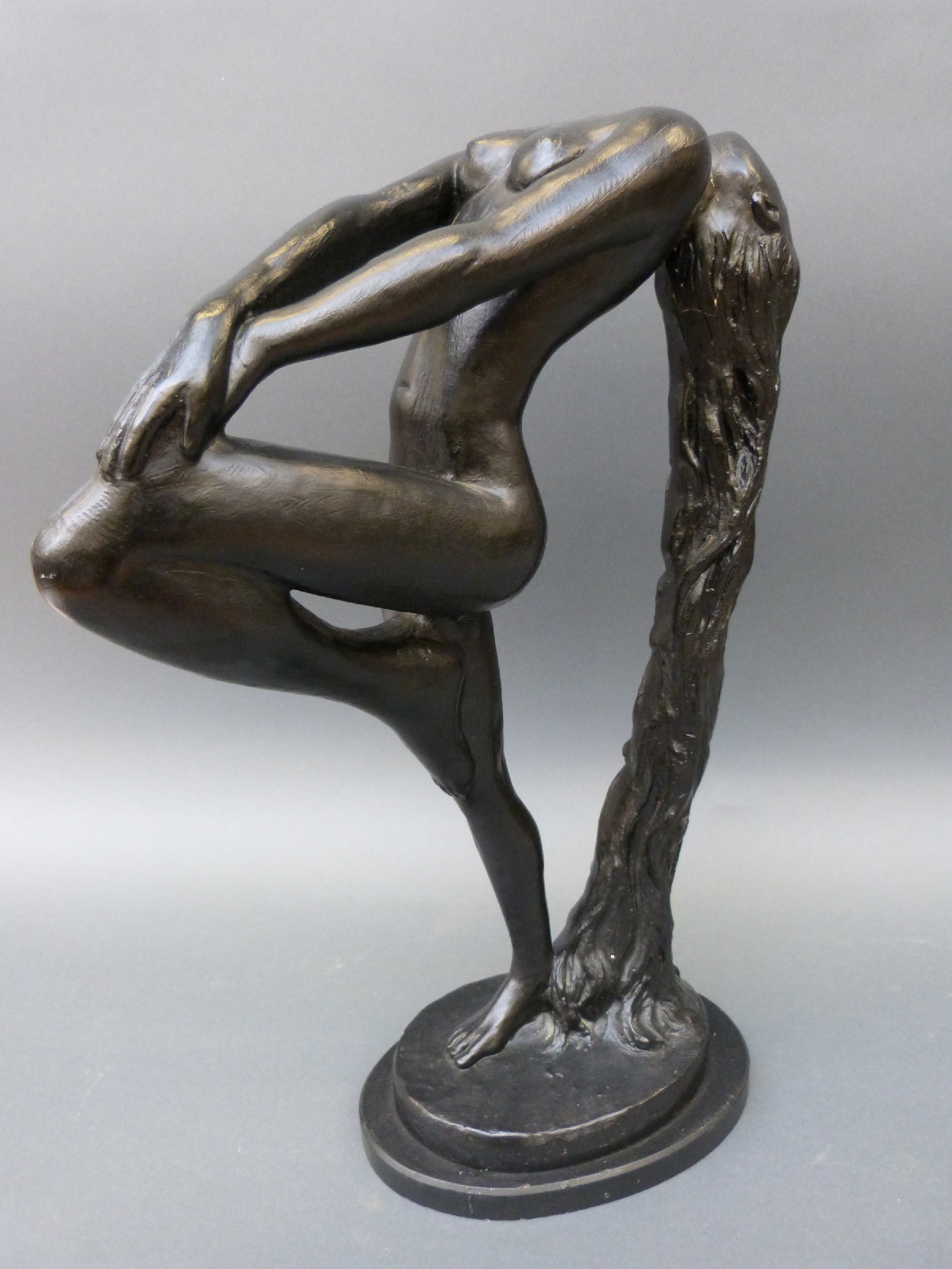 A black statue of a girl with flowing hair, height 55cm