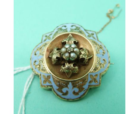 A Victorian mourning brooch set with blue enamel, seed pearls and a diamond, with glass compartment verso