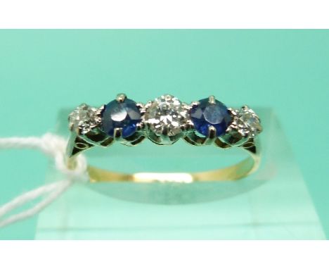 An 18ct gold ring set with alternating diamonds and sapphires (Size N)