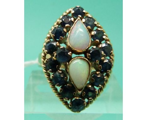 An 18ct gold ring set with two teardrop shaped opal cabochons and sapphires in a marquise shaped setting (Size R)