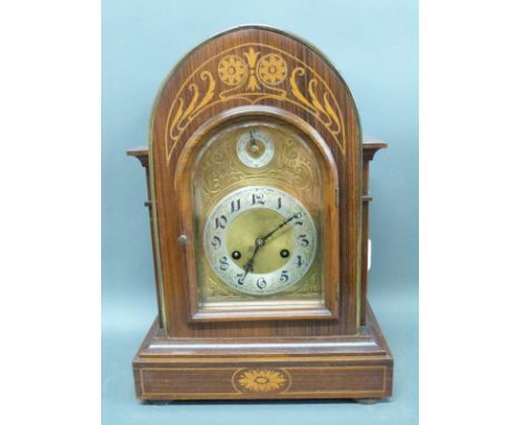 A mahogany cased mantel clock with domed top, the chased brass dial with contrasting silvered Arabic chapter ring beetle and 