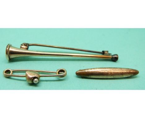 A gold brooch set with a pearl in the form of a shell and two other brooches