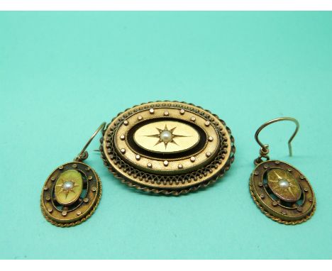 A Victorian yellow metal mourning brooch set with a pearl to the centre in a star setting with matching earrings