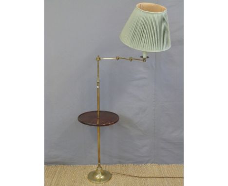 A brass library lamp with tray table and articulated arm, height approx 128cm
