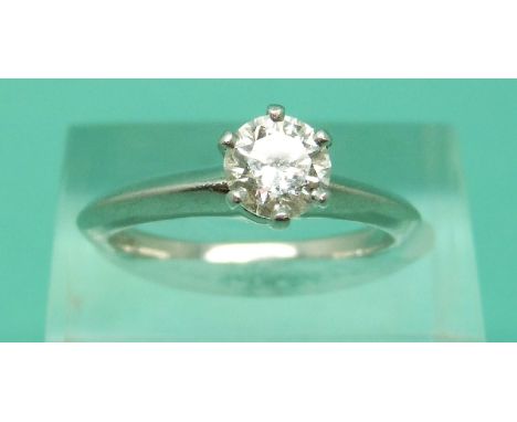 A platinum Tiffany & Co ring set with a modern round brilliant cut diamond measuring 0.79ct with original box, certificate an