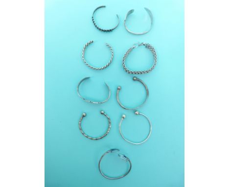 A quantity of silver bangles, one set with mother of pearl and lapis lazuli 