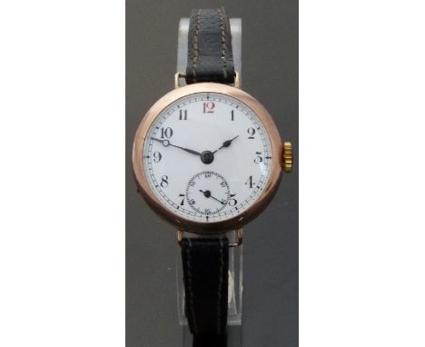 A Swiss 9ct gold wristwatch with blue hands, subsidiary seconds dial, Arabic numerals and white enamel face, on black leather
