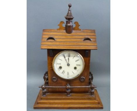 A German mantel/shelf clock in the form of a building with steps around the base, the Roman dial with spear hands, striking o