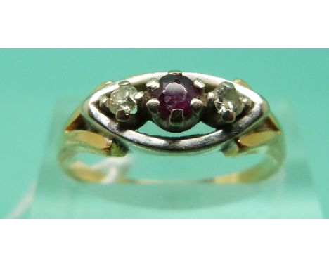 An 18ct gold ring set with a ruby and two diamonds in a platinum setting (Size P)