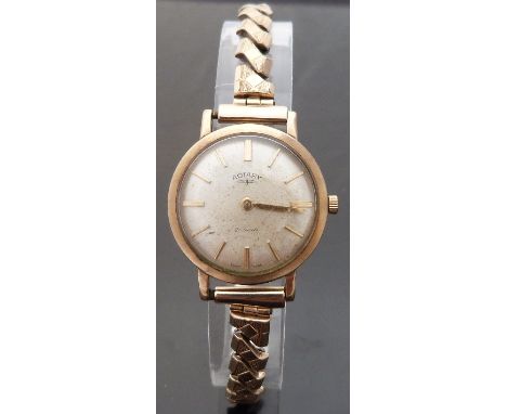 Rotary 9ct gold ladies wristwatch with gold hands and baton markers and champagne face, on expanding metal bracelet, case dia