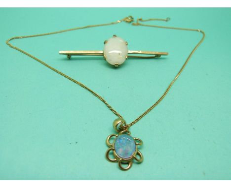 A 9ct gold brooch set with an oval opal cabochon and a 9ct gold pendant set with an opal doublet on 9ct gold chain 