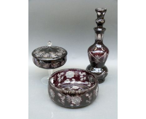 Three pieces of flash overlaid cut glassware comprising a pedestal covered bowl, fruit bowl and a decanter, tallest 40cm