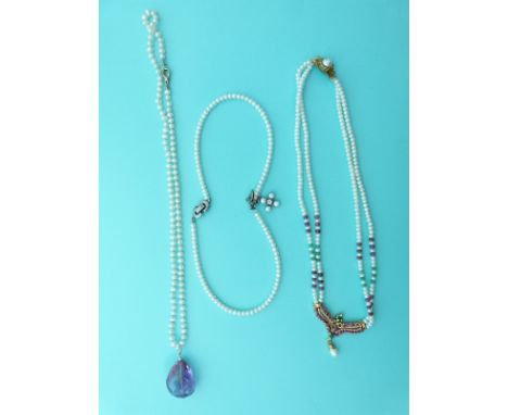 A two strand pearl necklace set with rubies and emeralds in a pendant, single strand pearl necklace with a briolette amethyst