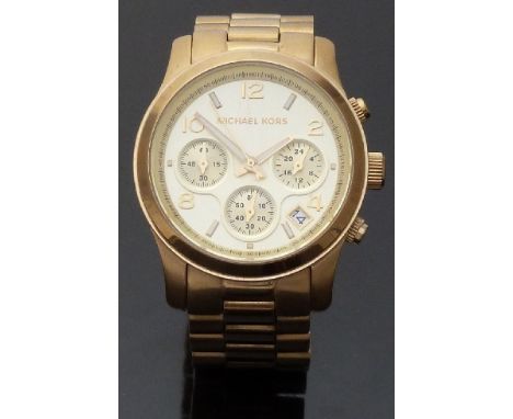 Michael Kors gold plated ladies chronograph wristwatch with date aperture and luminous hands and markers, on metal bracelet, 