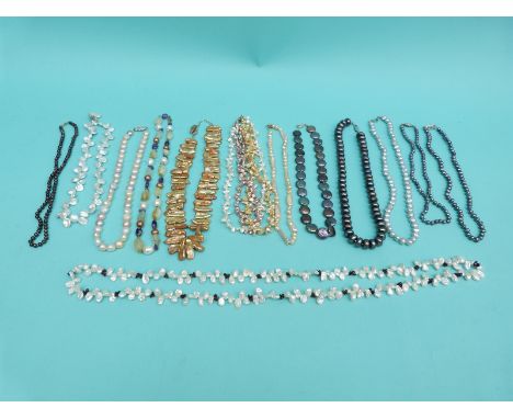 Thirteen pearl necklaces including freshwater and cultured, examples one with a 14ct gold clasp