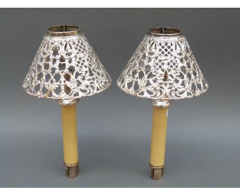A pair of Gorham white metal pierced lamp shades with spring loaded candle bases, diameter of shades 14.5cm
