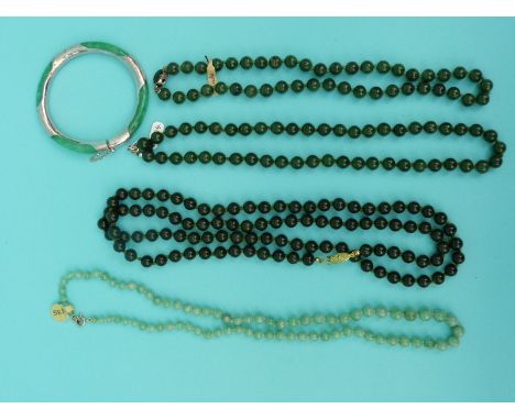 Four jade/ jadeite beaded necklaces and a silver and jadeite bangle 