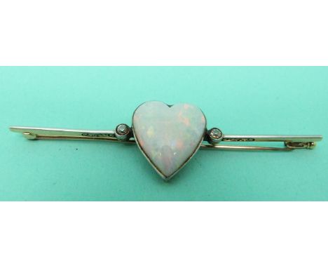 A Victorian brooch set with a heart shaped opal cabochon and two diamonds 