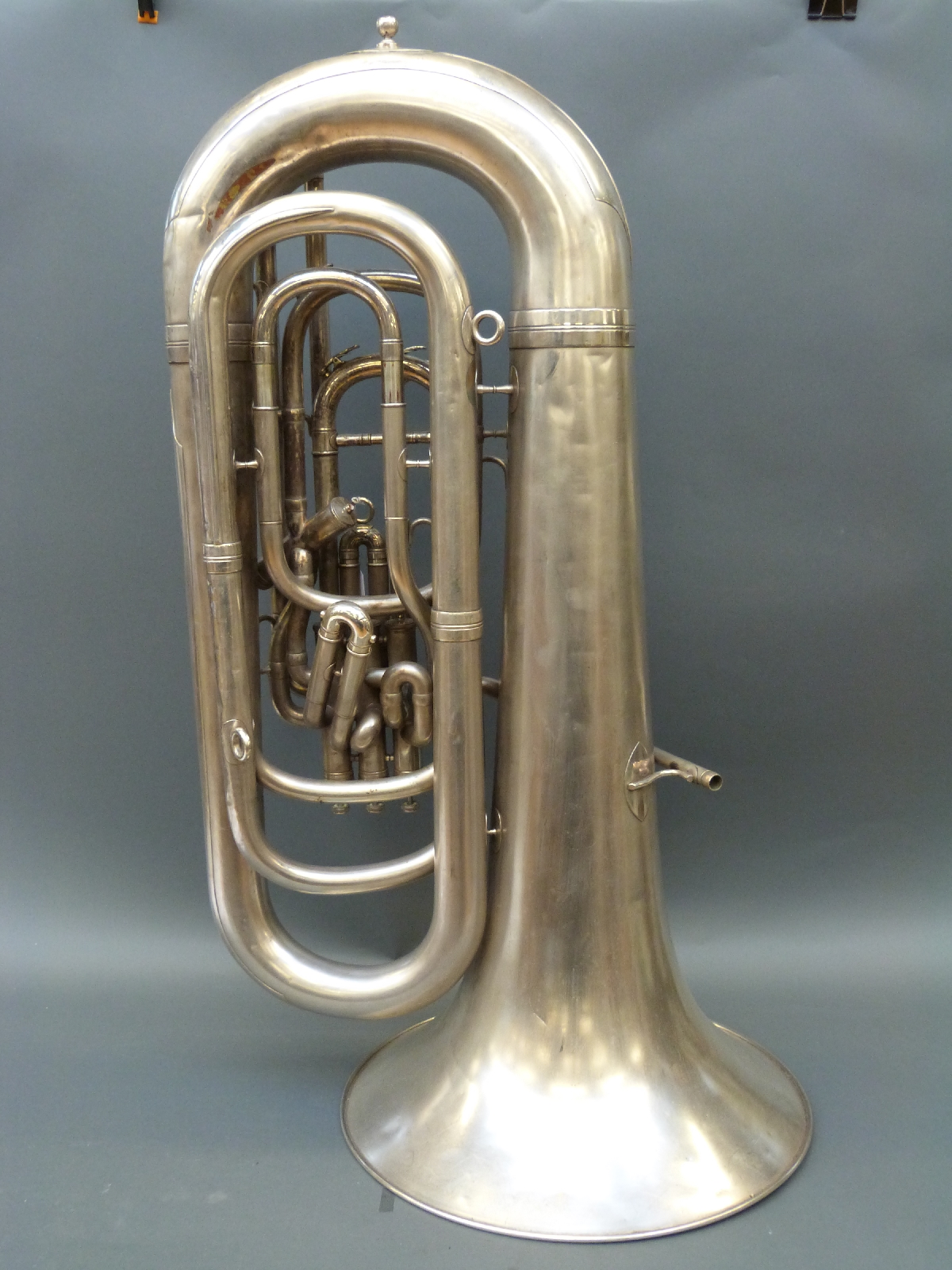 A cased E Flat tuba by Boosey & Hawkes in silvered finish, 104cm long