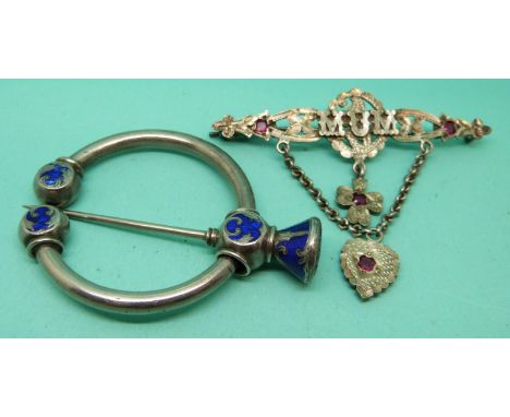 A silver brooch reading 'mum' set with four rubies and a silver kilt pin set with blue enamel. 