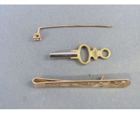 A 9ct gold tie clip and a 9ct gold stick pin set with a diamond