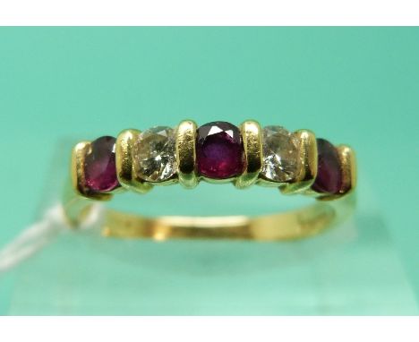 An 18ct gold ring set with alternating rubies and diamonds (Size K)