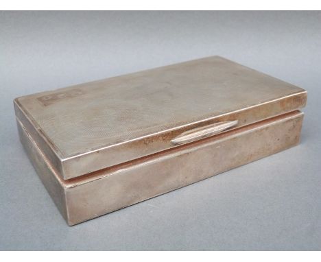 A hallmarked silver cigarette case with engine turned decoration, Birmingham 1962, width 14.5cm