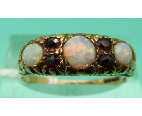 A 9ct gold ring set with opals and garnets (Size Q)