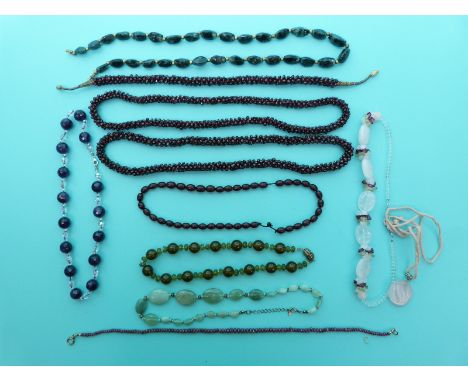 Three beaded garnet necklaces, a beaded ruby example made up of faceted beads, agate necklace, amethyst necklace etc 