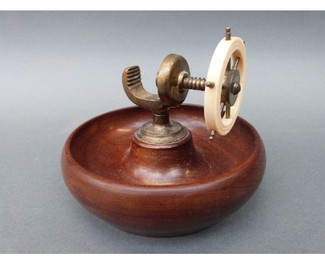 A retro turned wood and brass nutcracker in the form of a ship's wheel, diameter 18cm