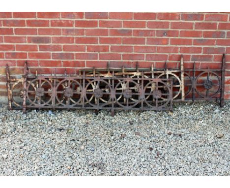 A GROUP OF THREE SECTIONS OF VICTORIAN CAST IRON RAILING with rosettes within circles, the largest piece 164cm long x 49cm hi