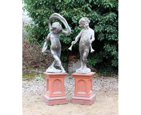 A PAIR OF OLD LEAD GARDEN STATUES of children, one dancing, the other playing a pair of pipes, both mounted on terracotta pli