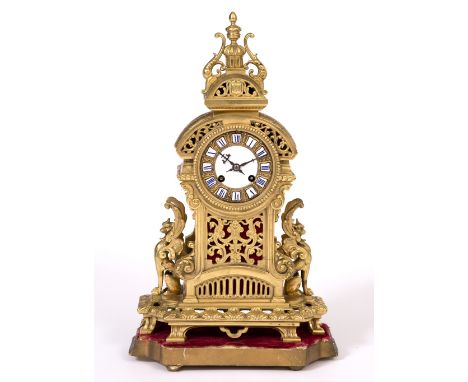 A LATE 19TH / EARLY 20TH CENTURY FRENCH GILT METAL MANTLE CLOCK with white enamel dial and blue painted Roman numerals, with 