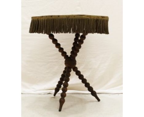 A cloth covered cricket table on turned tripod legs 68 x 56 x 56cm