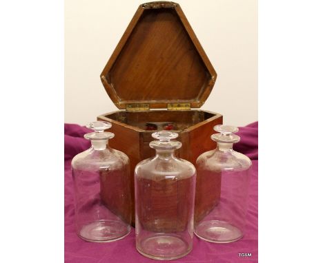 A mahogany cased decanter Tantalus with 3 matching bottles 23cm high