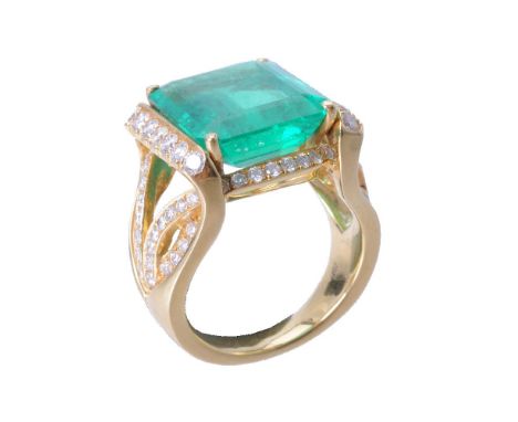 An emerald and diamond dress ring, the step cut emerald with canted corners estimated to weigh 9.69 carats, in a four claw se